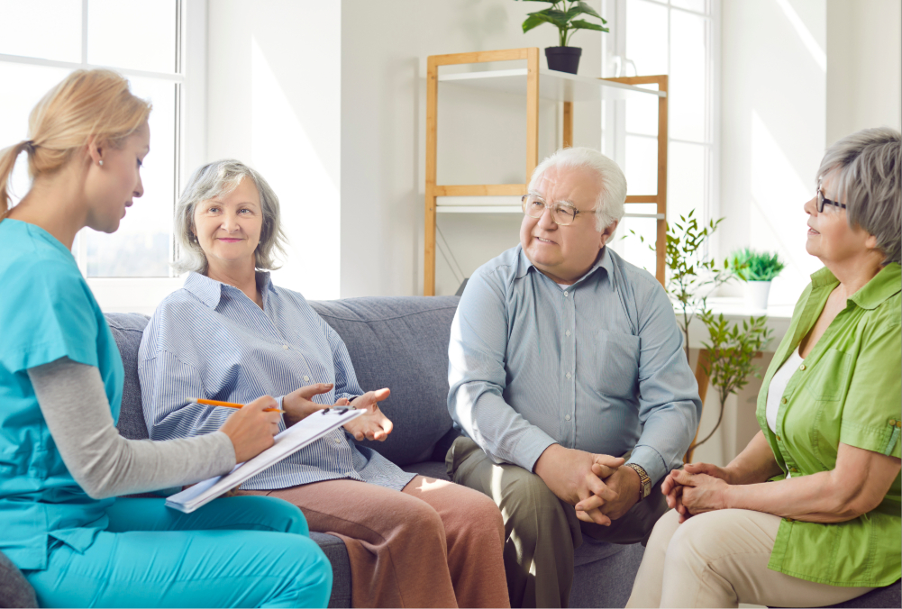 Wellness Programs 1 Elderly group talking with nurse who is taking notes on a clipboard.